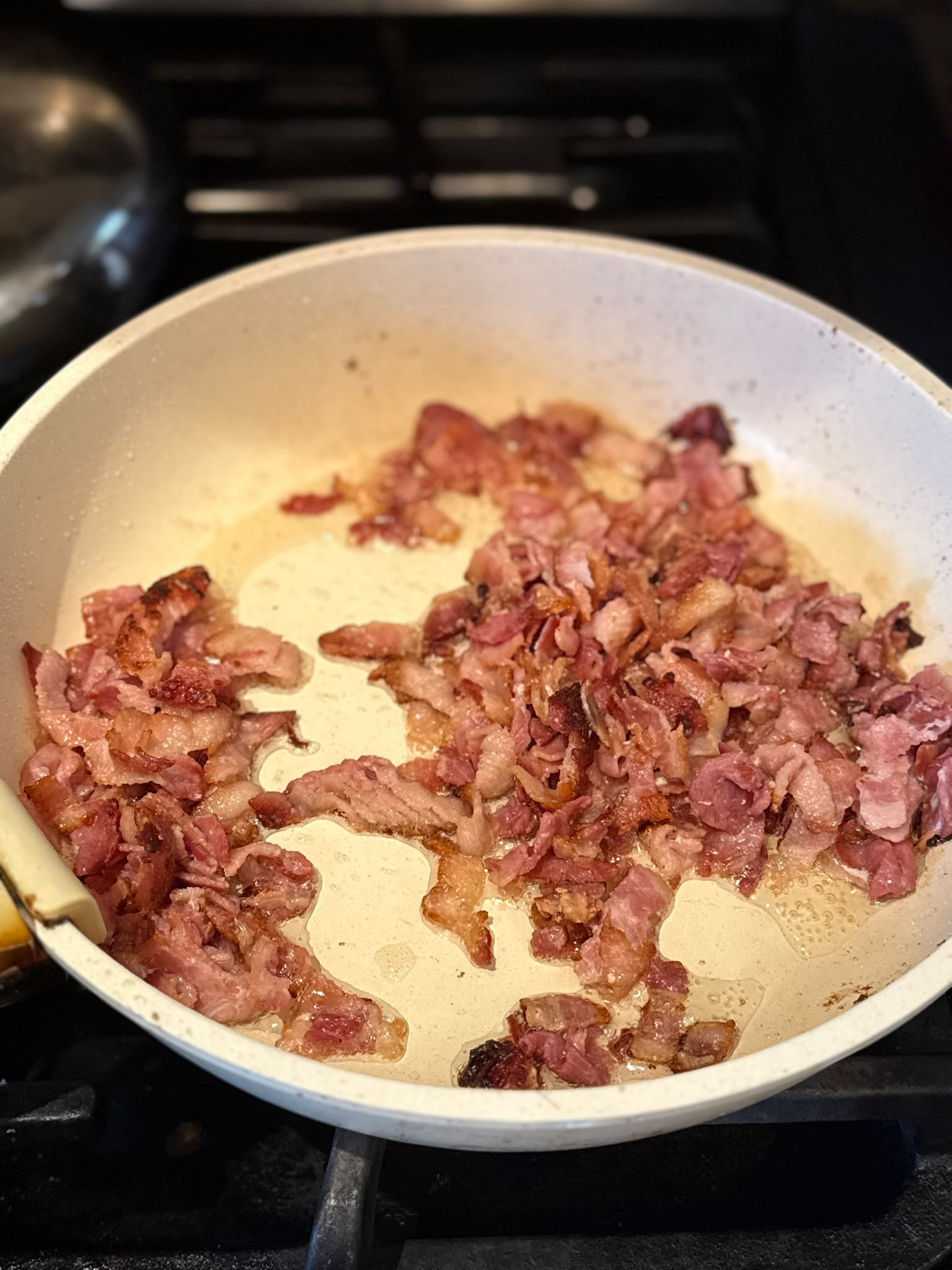 Bacon rendered crisp and golden in the pan. Start it from cold so the fat renders slowly — those golden drippings are pure flavour.